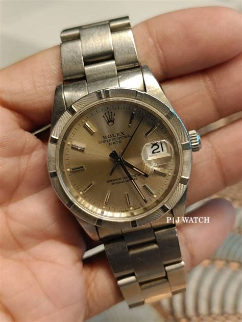 rolex oyster perpetual date engine turned bezel